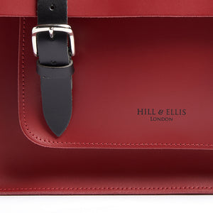 Red leather satchel cycle bag detail of Hill & Ellis logo embossing