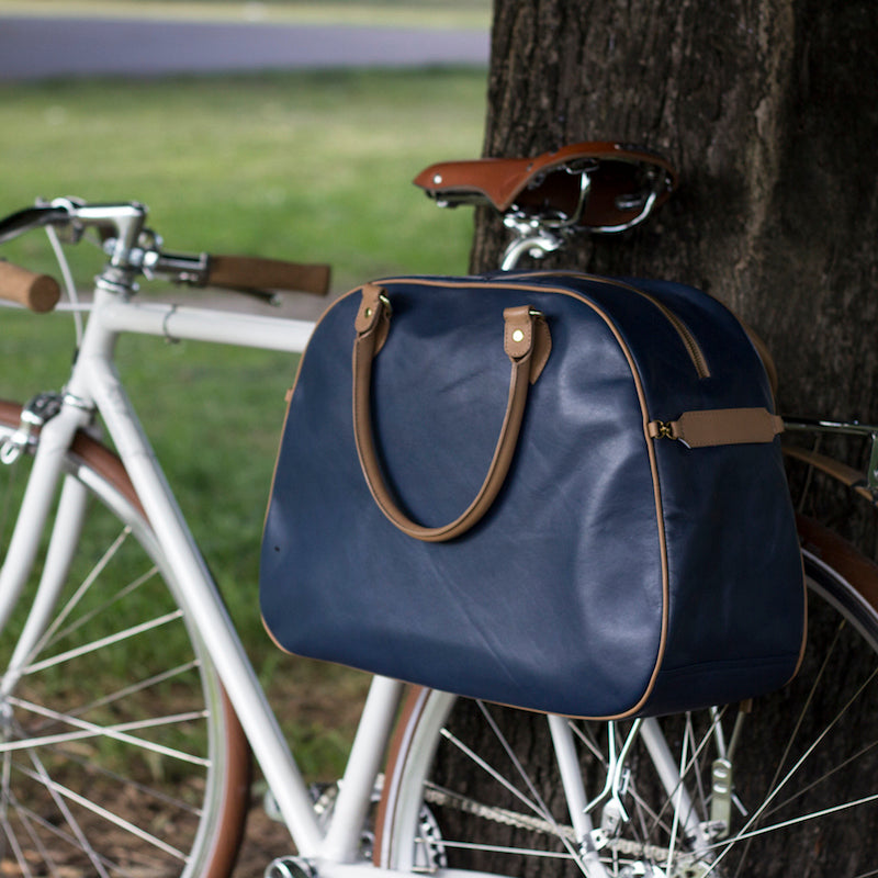 Blue and tan leather cycling bag on bicycle