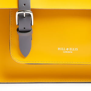 Yellow leather satchel cycle bag detail of Hill & Ellis embossing