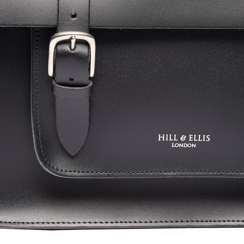 Black satchel cycle bag with detail of Hill & Ellis logo