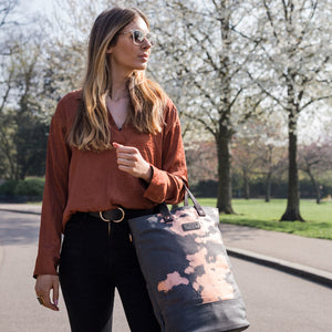 Copper print canvas cycling bag carried by a model