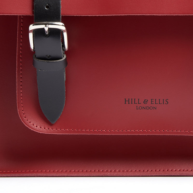
            
                Load image into Gallery viewer, Red leather satchel cycle bag detail of Hill &amp;amp; Ellis logo embossing
            
        
