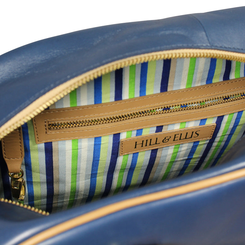 
            
                Load image into Gallery viewer, Blue and tan leather cycling bag inside
            
        