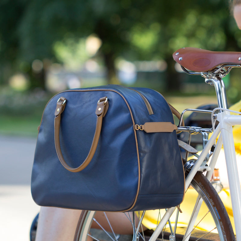 Blue and tan leather cycling pannier bag on bicycle