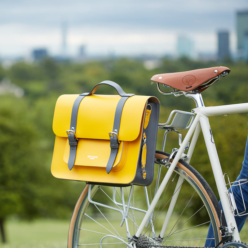 Yellow leather satchel cycle bag attached to bicycle