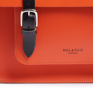 Orange leather satchel cycle bag detail of embossing