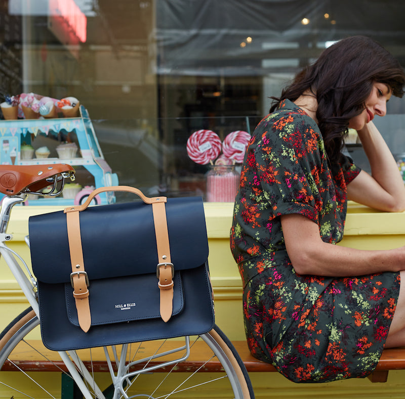 Navy and Tan leather satchel cycle bag attached to a bicycle