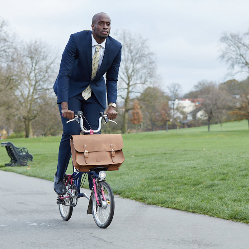 
            
                Load image into Gallery viewer, Tan leather Brompton compatible cycle bag modelled on brompton bicycle
            
        