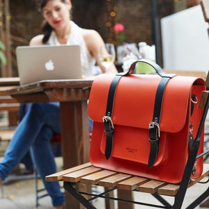 Orange leather satchel cycle bag in cafe